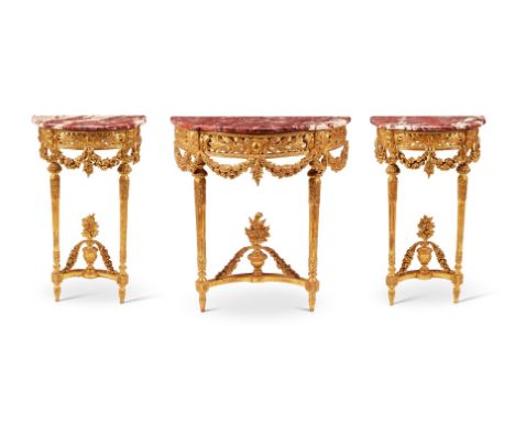 A SUITE OF THREE FRENCH GILTWOOD CONSOLE TABLESLATE 19TH CENTURYIn the Louis XVI style, with red marble tops above swag decor