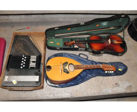 THREE STRINGED MUSICAL INSTRUMENTS comprising of a Schengrin Autoharp in half its original box, a Chinese Violin in case with