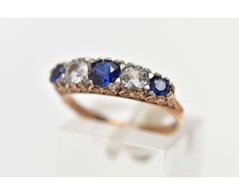 A 9CT YELLOW GOLD FIVE STONE RING, set with three circular cut blue sapphires and two circular cut colourless cubic zirconia,