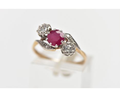 A YELLOW METAL RUBY AND DIAMOND CROSSOVER RING, centering on a circular cut ruby in an eight claw setting, flanked with illus