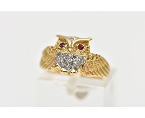 A YELLOW METAL GEM SET RING, in the form of an owl with spread wings, the body is set with single cut diamonds and two circul