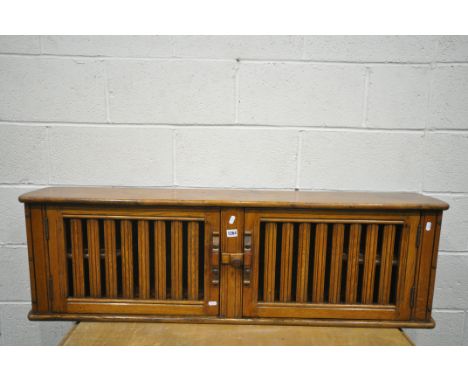 AN ERCOL TWO DOOR HANGING WALL SHELF, with two small internal shelves, length 130cm x depth 24cm x height 40cm (condition - u