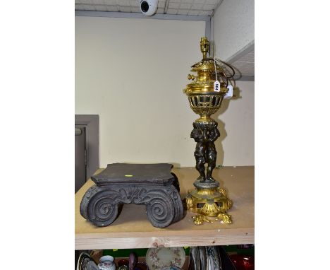 A DECORATIVE ELECTRIC TABLE LAMP IN THE FORM OF AN OIL LAMP, comprising a cast brass base, reservoir holder and lamp fitting 