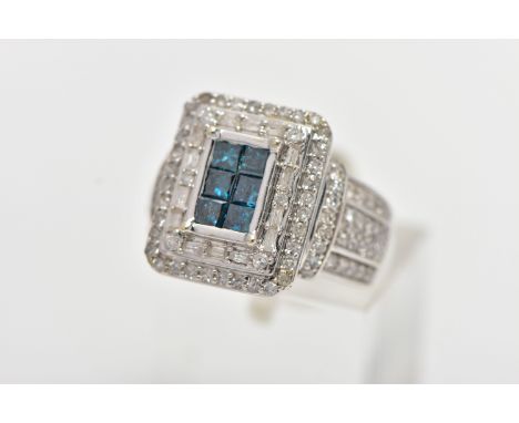 A WHITE METAL DIAMOND DRESS RING, of a rectangular form, to the centre is six princess cut blue diamonds, within a tiered sur