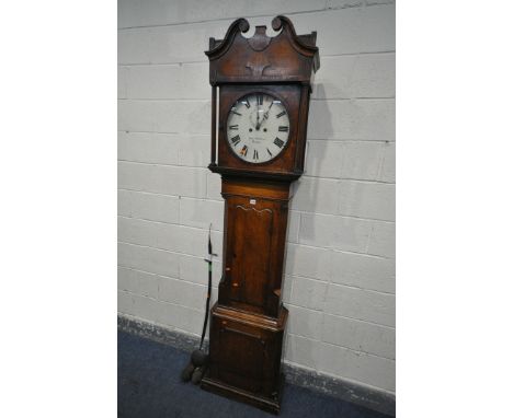 A GEORGIAN OAK EIGHT DAY LONGCASE CLOCK, the hood with a swan neck pediment, reeded pillars flanking a circular door, that's 