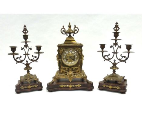 A late 19th/early 20th century mantel clock, the movement striking on a bell, the face with white enamelled hour markers with
