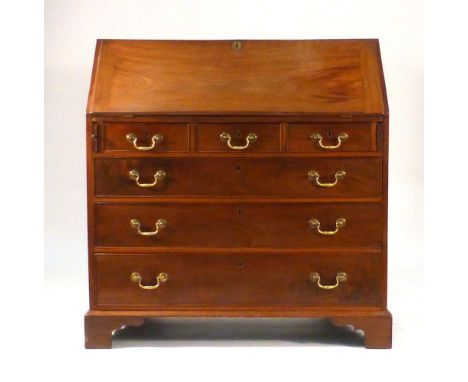 A George III mahogany bureau, the fall front enclosing a fitted strung interior over three short and three long graduated dra
