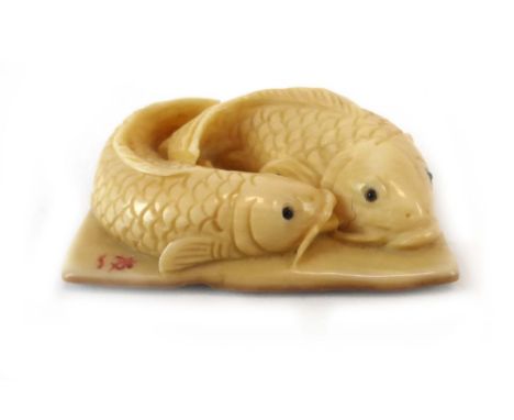 A 19th century Japanese carved ivory netsuke of rectangular form carved with a pair of carp, signed, w. 3.5 cm CONDITION REPO