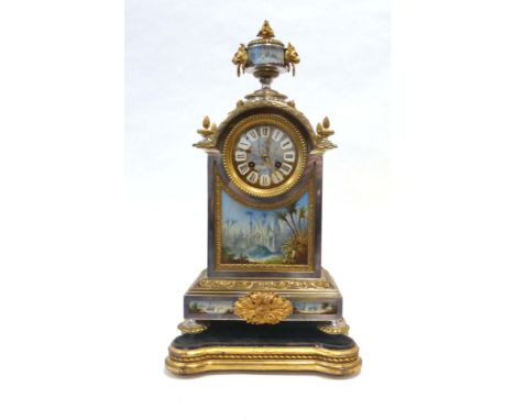 A late 19th century-style mantle clock, with a French movement in a silvered and gitl metal architectural case surmounted by 