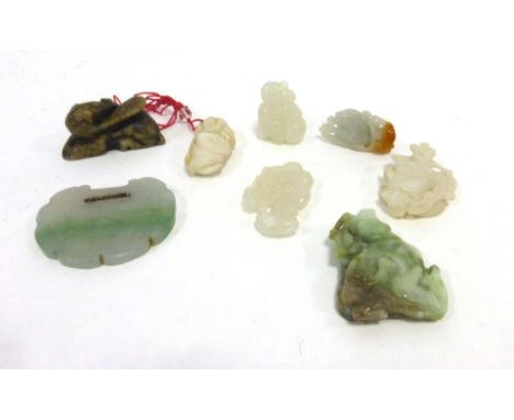 A Chinese white jade pendant modelled as a figure holding a gourd, h. 3.5 cm, together with seven further jade and hardstone 