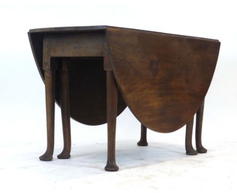 An 18th century mahogany gate-leg dining table, the circular legs on pad feet, max. l. 164 cm