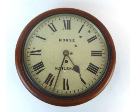A late 19th century wall clock, the enamelled face with Roman numerals, inscribed 'Morse Hailsham', within a circular mahogan