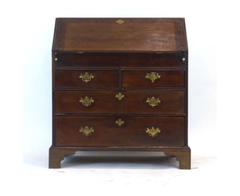 A late 18th century and later mahogany bureau, the fall-front enclosing a fitted interior over an arrangement of two short an