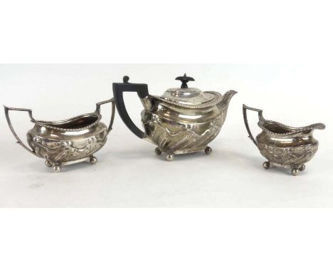 A Victorian silver three piece tea service of boat shaped form repousse decorated in the Neo-Classical manner, maker TB, Lond