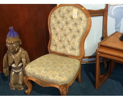 A carved walnut button back nursing chair