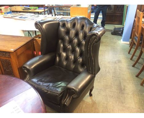 A good pair of Chesterfield wing back armchairs, with button backs, supported on cabriole legs