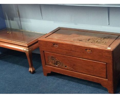 A carved Oriental camphor wood lined trunk and matching coffee table