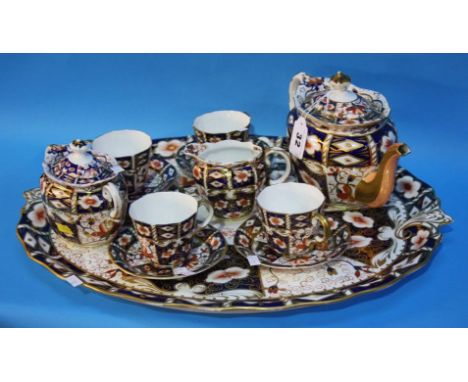 A Royal Crown Derby Imari pattern cabaret set comprising; tray, four tea cups and saucers, cream jug and sugar bowl