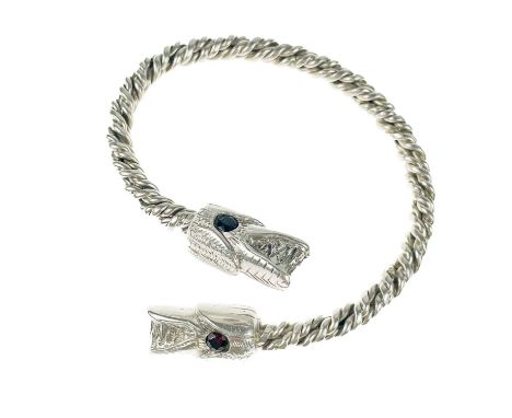 A .999 fine silver 'Viking Dragon' bangle by James Suddaby. The dragon head terminals with garnet set eyes, hallmarked, 68g.