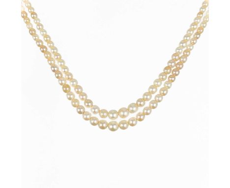 An early 20th century graduated two strand pearl necklace with white gold diamond set clasp. The rectangular panel clasp with