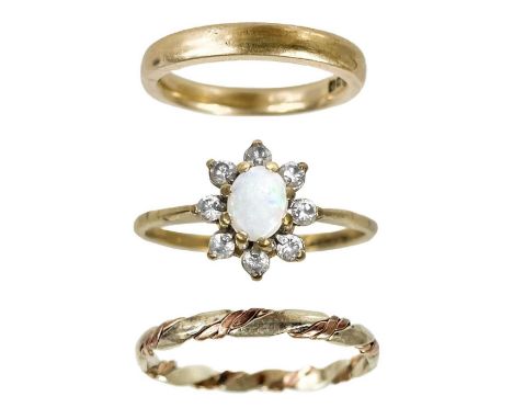 Two 9ct band rings and an opal white stone set cluster ring. One in rose gold, size J, the other in twisted rose and white go