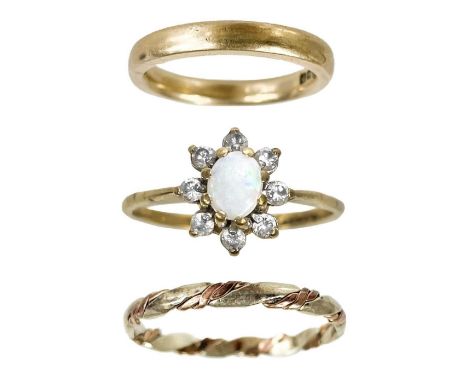 Two 9ct band rings and an opal white stone set cluster ring. One in rose gold, size J, the other in twisted rose and white go