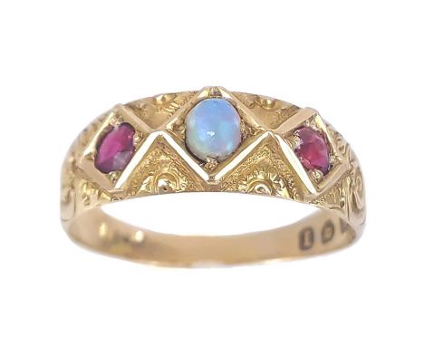 A Victorian 18ct opal and garnet set three stone ring. The stones in a lozange setting and foliate scroll engraved, maker WM,