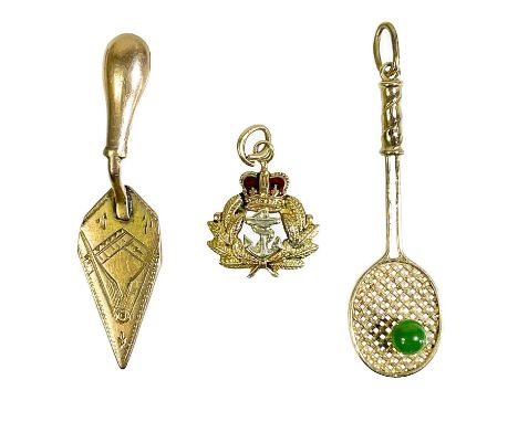 Three gold charms. One is a 9ct and enamel Royal Navy charm, Birmingham 1956, one in the form of a tennis racket with green s