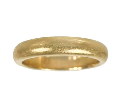 An 18ct band ring. D-section, Birmingham 1928, size K 1/2, 5.4g.