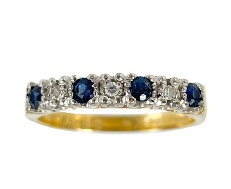 An 18ct diamond and sapphire seven stone ring. The four small round cut sapphires of 0.05ct, with three smaller diamonds, sta