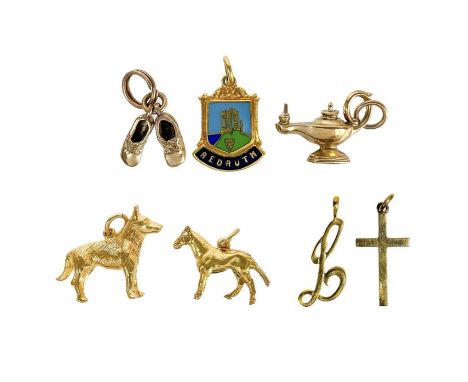 A collection of seven 9ct charms. To include a heavy Alsatian dog charm, other in the form of a horse, lamp, letter L, Redrut