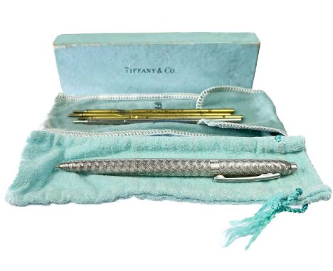 A Tiffany & Co sterling silver roller ball pen. Engine turn decoration, stamped STERLING GERMANY TIFFANY &amp; CO, with four 