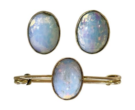 A 15ct gold synthetic opal set pin brooch and pair of matching stud earrings. The pin brooch stamped 15ct, length 34mm, the o