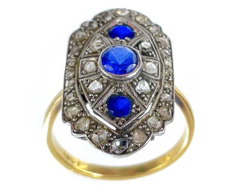 An Art Deco period 18ct yellow and white gold diamond and sapphire panel ring. The white gold panel with millegrain set small