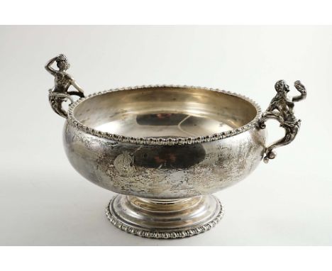 AN EDWARDIAN SQUAT CIRCULAR ROSE BOWL with bobbin-bead borders and two cast Bacchanalian figure handles, with a small inscrip