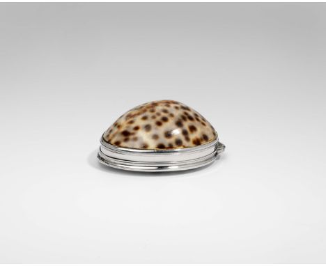 AN EARLY GEORGE II SILVER MOUNTED COWRIE SHELL SNUFF BOX with an engraved coat of arms* on the cover, gilt interior, unmarked