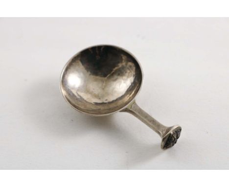 AN EARLY 20TH CENTURY ARTS &amp; CRAFTS CADDY SPOON with a hammered circular bowl &amp; a square section stem with a chased f