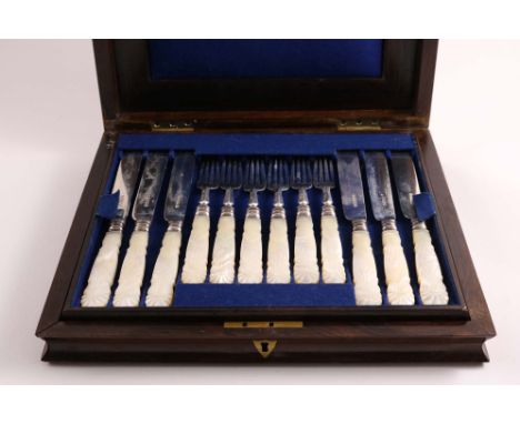 A VICTORIAN CASED SET OF TWELVE PAIRS OF DESSERT KNIVES &amp; FORKS with carved, mother of pearl handles, crested, by H. Wilk