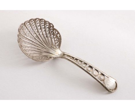 A GEORGE III FILIGREE CADDY SPOON with an initialled oval cartouche at the top of the stem, unmarked, Birmingham-made, c.1800