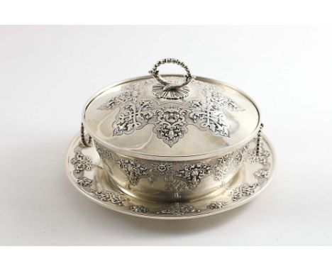 A VICTORIAN CIRCULAR BUTTER DISH AND COVER with matching stand, the whole decorated with linked,a chased reserves of interlac