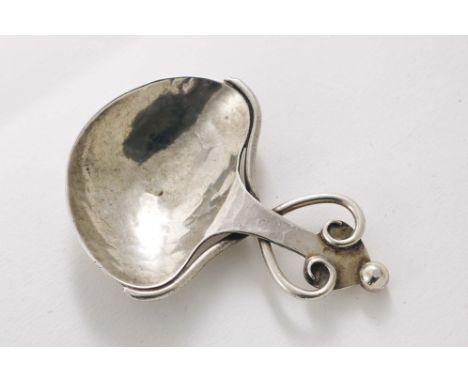 AN ARTS &amp; CRAFTS CADDY SPOON with a heart-shaped bowl with a hammered finish and wire scroll adornment, bead finial, by A