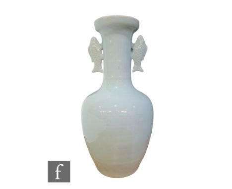 A Chinese Longquan style pale celadon vase, of bottle form rising to a dish mouth, flanked by twin fish handles, signed to ba