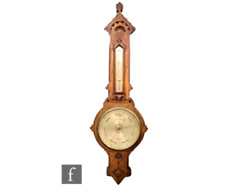 A 19th Century Gothic cased oak barometer by Negretti &amp; Zambra incorporating a thermometer over a named dial, height 110c