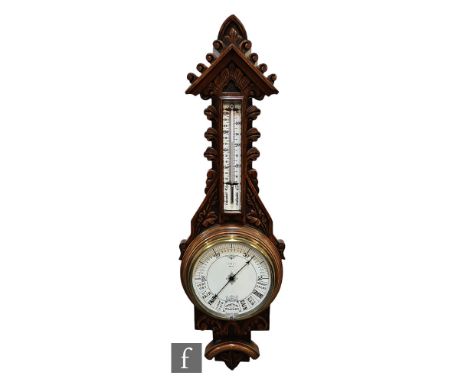 A Victorian carved oak aneroid barometer incorporating thermometer, the dial Great Gales to Very Dry within brass bezel, heig