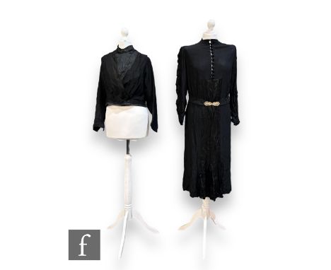 An early to mid 20th Century lady's vintage black silk dress, with high neck finished with button detailing,&nbsp;ruched long