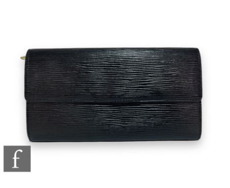 A 1990s Louis Vuitton black Epi leather Porter Tresor long wallet, with fold-over front flap, embossed logo to the right corn