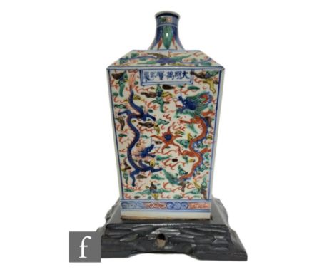 A Chinese Wucai glazed 'Dragon' vase, the square section vase rising to a tapered neck, each side with opposing dragons in pu