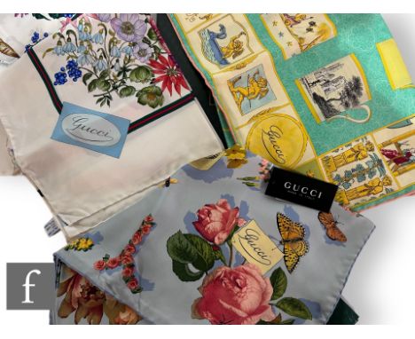 A Gucci silk scarf in the Teacup pattern, decorated with rows of patterned teacups over a turquoise ground with a border cont