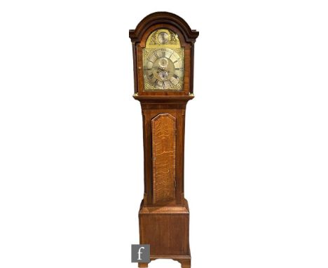 A late 18th Century oak and mahogany cross-banded longcase clock with an eight-day movement, the 12 inch brass broken arch di