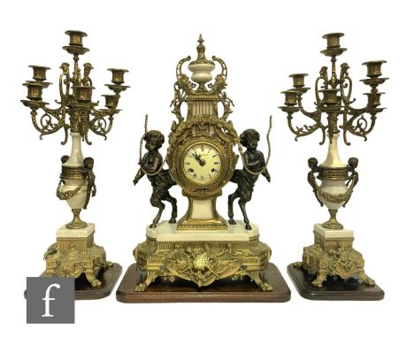 A late 20th Century Louis XVI style gilt clock garniture, the circular dial flanked by two bronze fawns with a pair of six br
